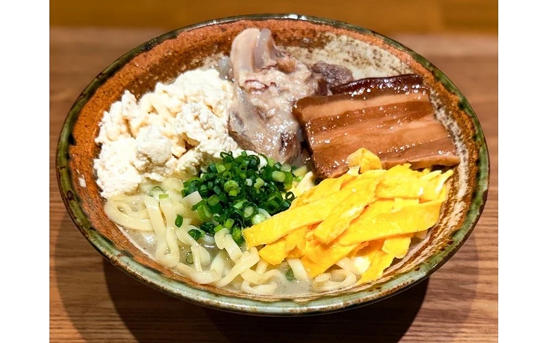 碗中盛有麵條，搭配豆腐、青蔥、豬軟骨、滷豬肉與蛋絲