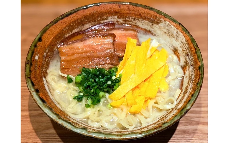 碗中盛有麵條，配料包括滷豬肉、青蔥與蛋絲
