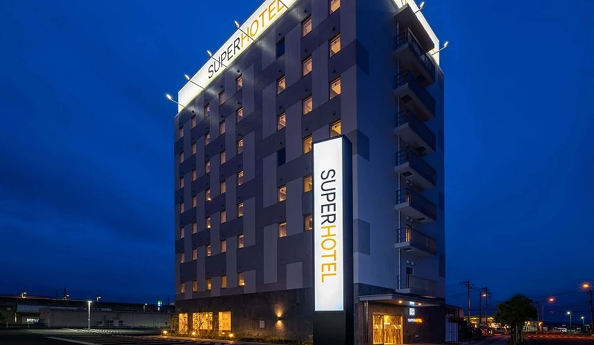 SUPER HOTEL高楼建筑在夜色中亮起灯光招牌