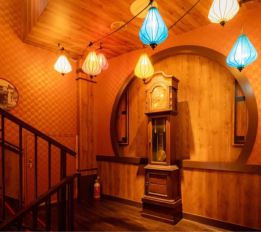 樓梯間有一座大鐘矗立,天花板則吊掛許多燈飾,頗有穿越時空之感