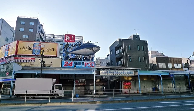 東京築地場外市場外觀,一整排商店建築上有巨大鮪魚看板與『24小時營業』招牌