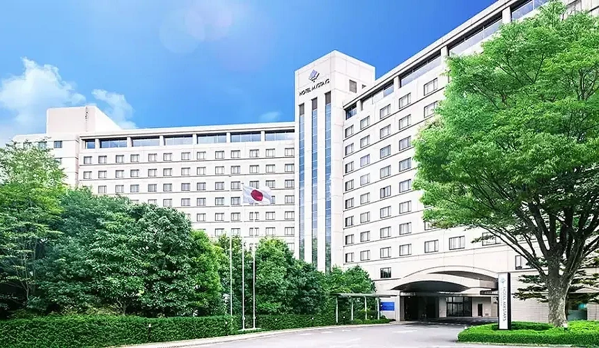 綠樹環繞的飯店外觀與日本國旗