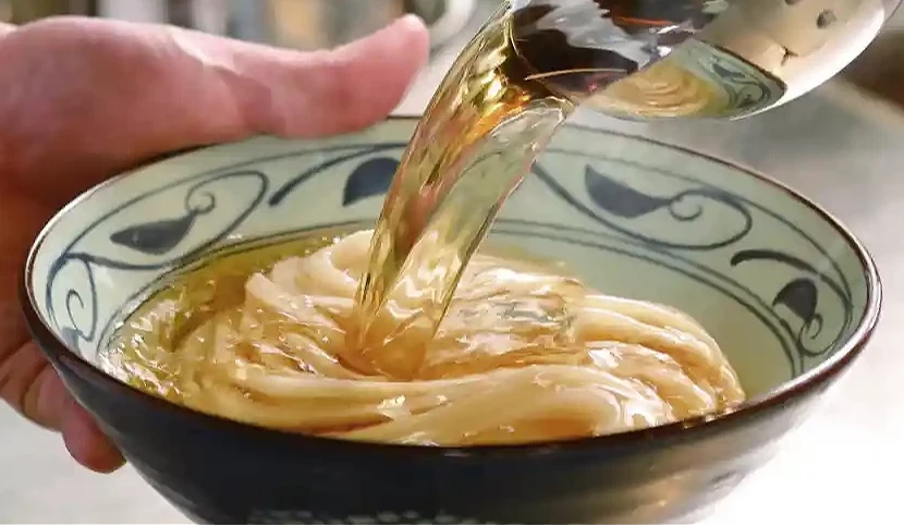 将汤汁倒入装有面的碗