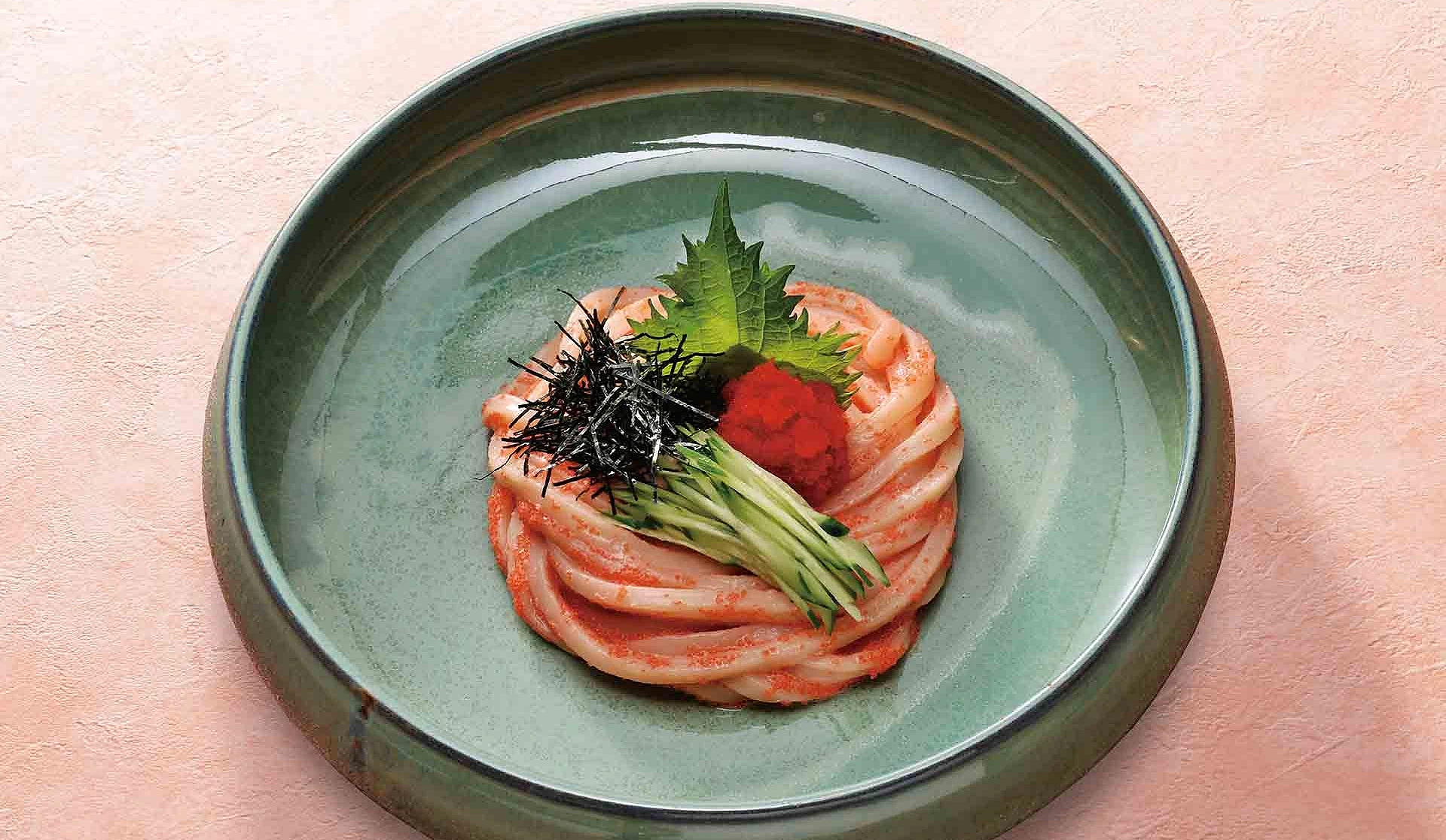 明太子乌龙面在绿色盘子上