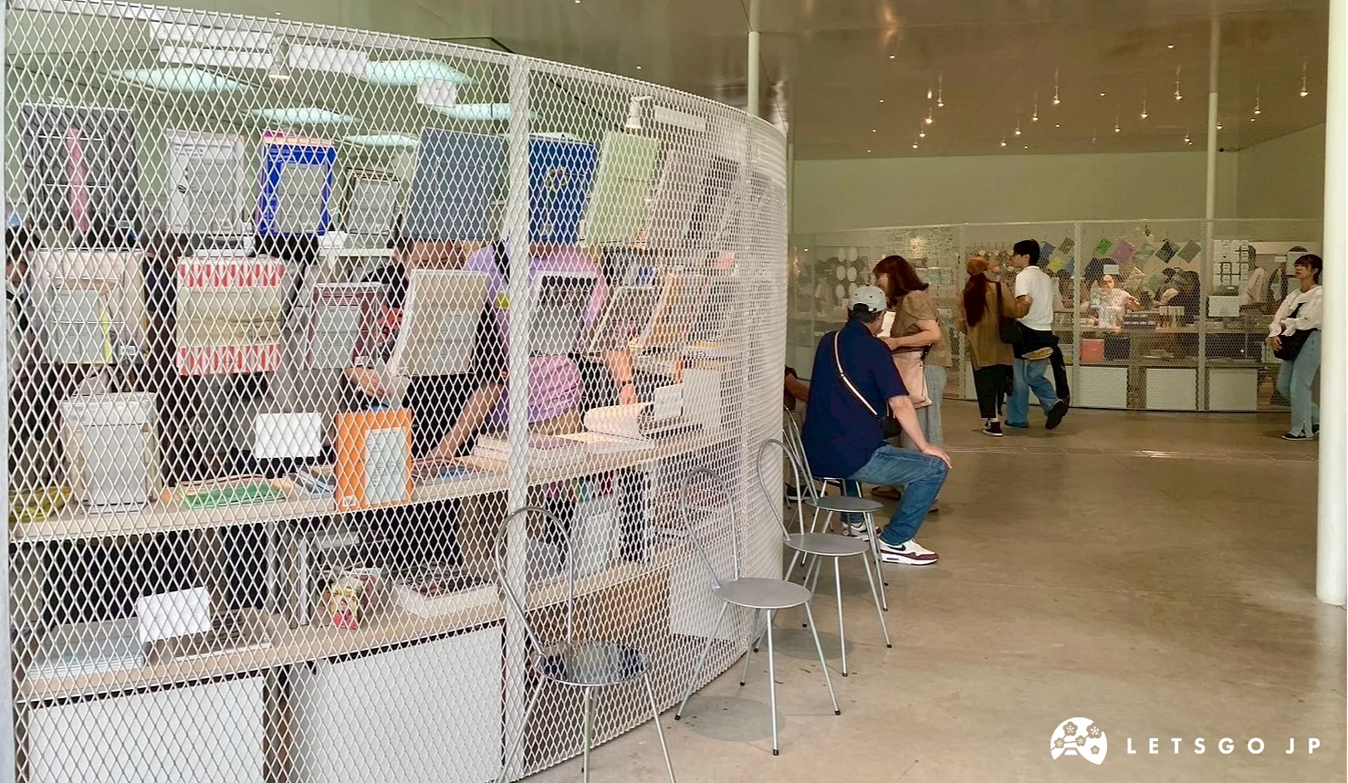 圓形圍欄的金澤21世紀美術館伴手禮區與路人