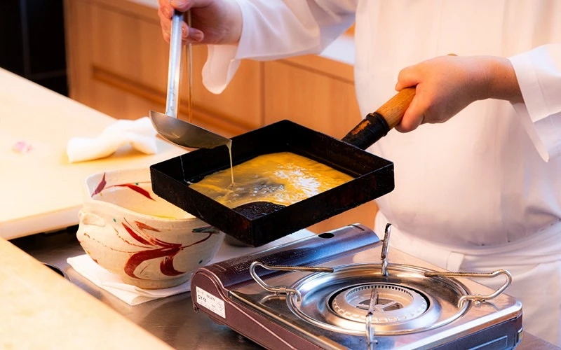 廚師手拿鍋子製作玉子燒