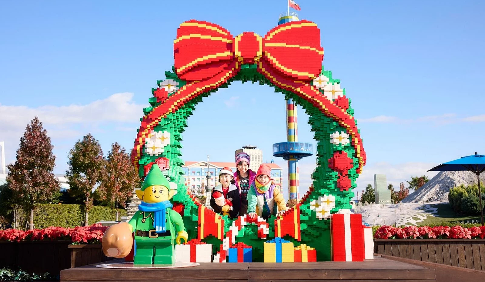 名古屋乐高乐园入口巨型乐高圣诞花圈拍照区,家庭与孩子们在花圈内合影