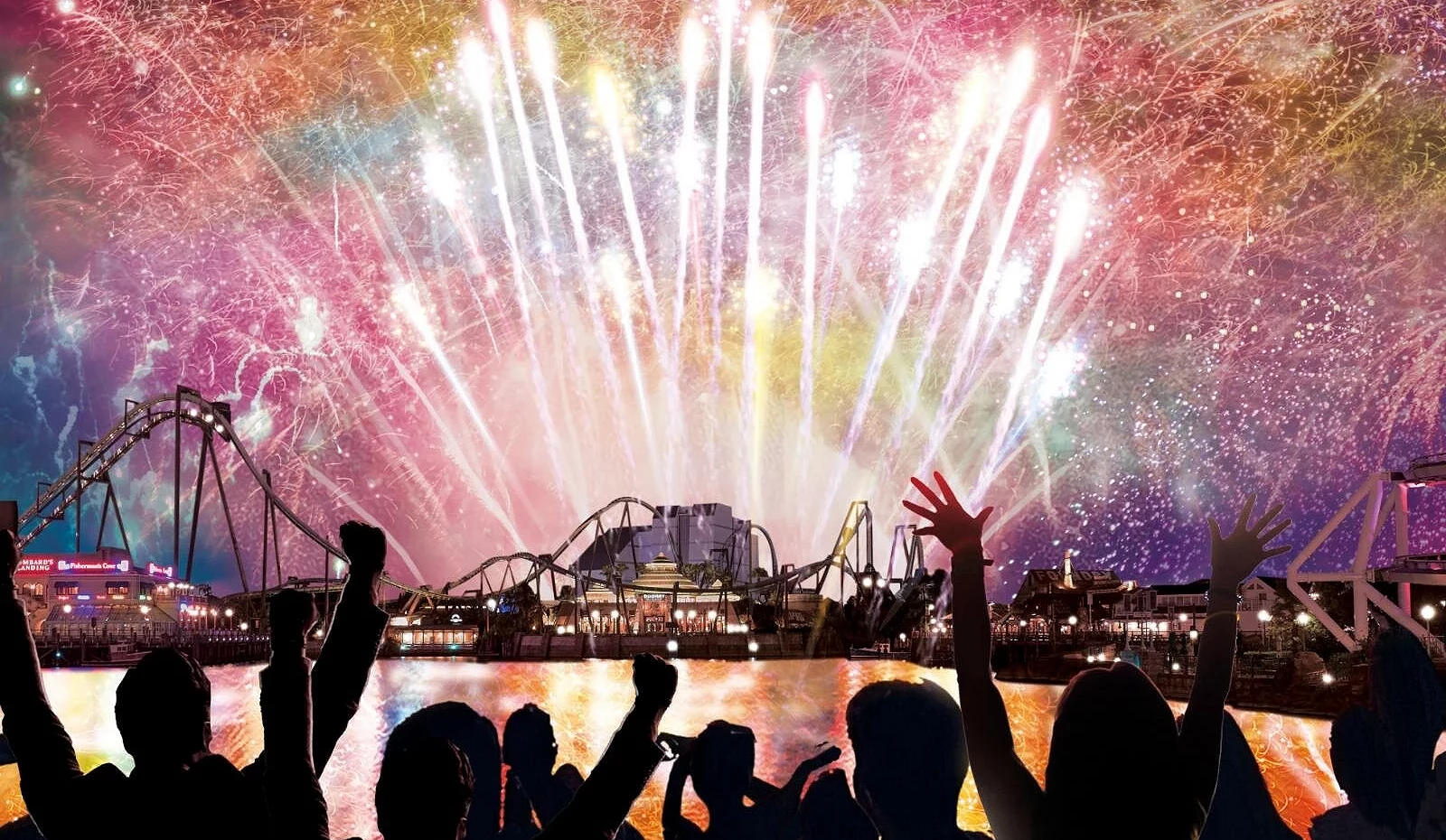 夜空中绽放大规模烟火,映照日本环球影城的园区设施,前景为旅客群众抬手欢呼,呈现跨年倒数的热闹场面