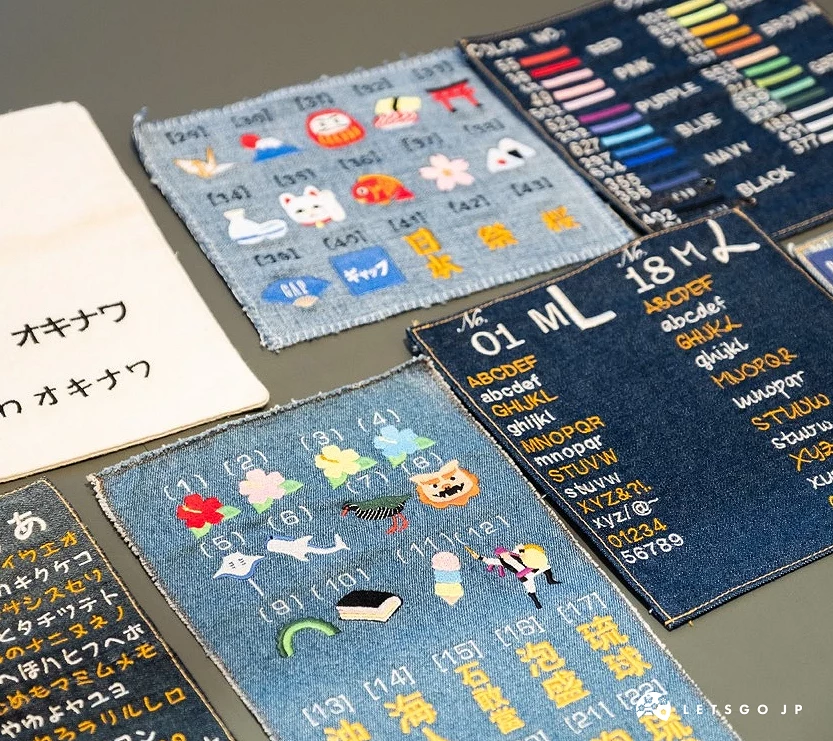 丹寧布上展示許多刺繡圖騰,包括沖繩限定的獅薩、苦瓜、飯糰等圖案
