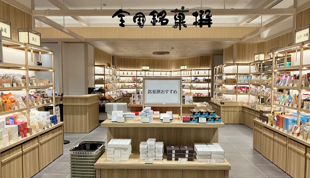 明亮的全国铭菓撰店铺入口,店内货架上堆满商品