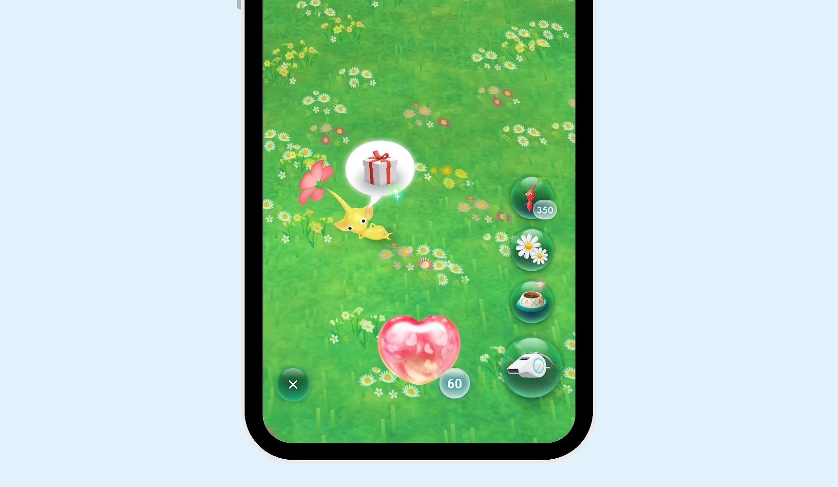 手机画面显示《Pikmin Bloom》游戏中一只皮克敏头上出现礼物图示,代表好感度达标可取得装饰或礼物,画面中有爱心精华与操作按钮
